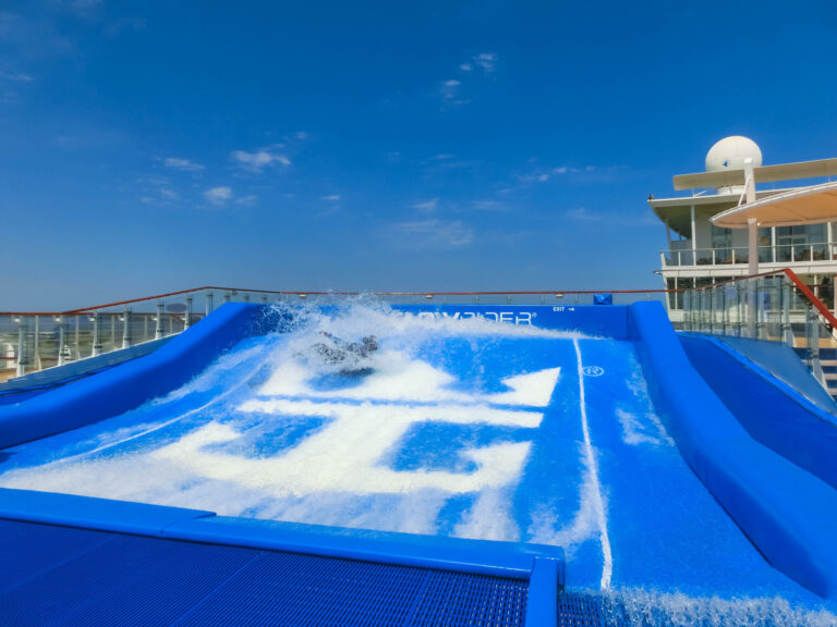Cape Canaveral, USA - APRIL 30, 2018: Woman surfing on the FlowRider aboard the Oasis of the Seas by Royal Caribbean